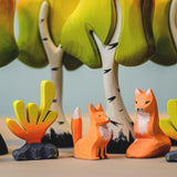 Bumbu animlas surrounded by Bumbu Wooden Birch Trees. The animals are of a bear with a squirrel sitting on its back
