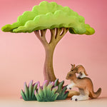 The Bumbu Toys Kangaroo in a small world play scene alongside wooden grass and trees.
