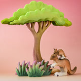 The Bumbu Toys Kangaroo in a small world play scene alongside wooden grass and trees.