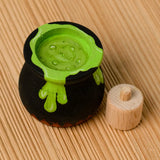 Bumbu handcrafted wooden black magic cauldron decorative figure showing the painted green potion inside