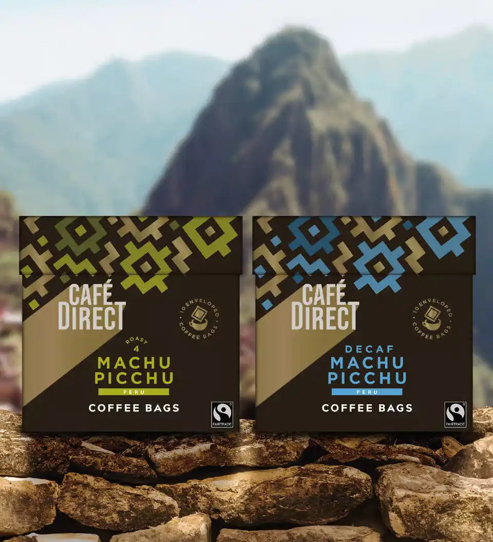 Cafedirect Machu Picchu Coffee Bags with fairtrade coffee for work and travel, with Peruvian mountains in the background.