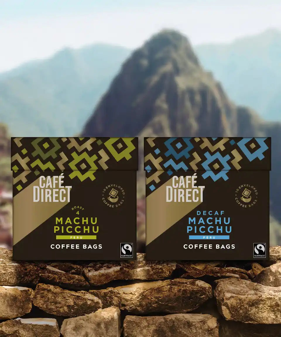 Cafedirect Machu Picchu Coffee Bags with fairtrade coffee for work and travel, with Peruvian mountains in the background.