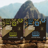 Cafedirect Machu Picchu Coffee Bags with fairtrade coffee for work and travel, with Peruvian mountains in the background.