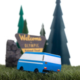 CandyLab blue VW T3 CandyVan with white stripe on the side - parked on grass with a tree in the background.