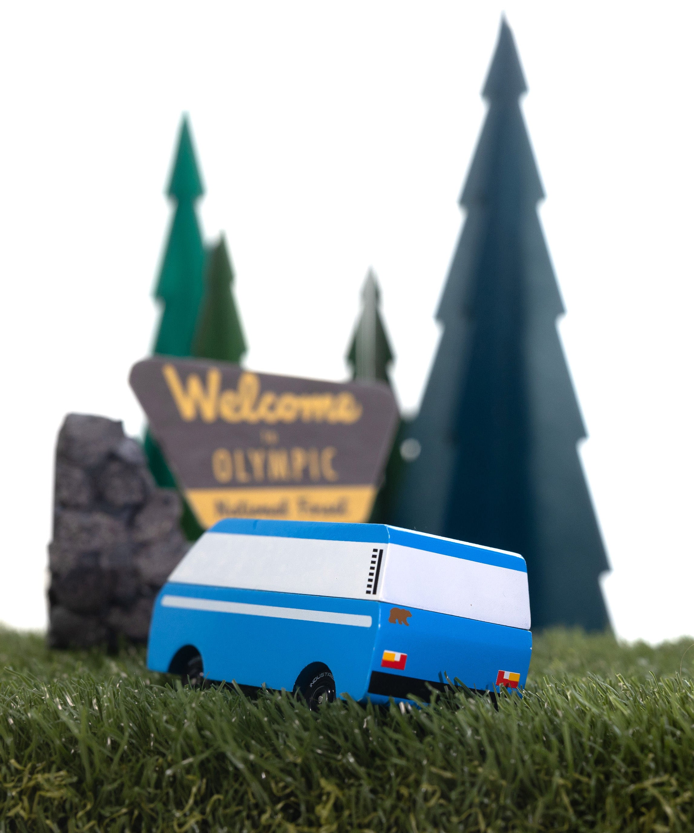 CandyLab blue VW T3 CandyVan with white stripe on the side - parked on grass with a tree in the background.