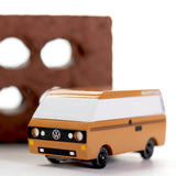 CandyLab Volkswagen T3 Campervan in brown - front view, photographed in front of a red brick.