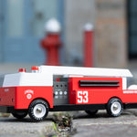 A Candylab Big Red Fire Engine pictured outdoors on a cobbled floor