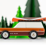 Side of the Candylab big sur car toy on a white floor in front of some tree toys
