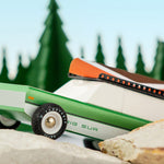 Close up of the Candylab childrens wooden big sur toy car on some large rocks