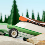 Close up of the Candylab childrens wooden big sur toy car on some large rocks