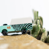 Close up of the Candylab kids wooden jeep toy on a rock next to a mini cactus