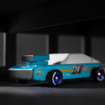 Close up of the Candylab children's seagull wooden race car toy in a black and grey background