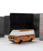 CandyLab Volkswagen T3 Campervan in brown - front view, photographed with a blurred black and white background.