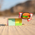 Candylab Burger Food Roadside Shack on a sandy surface outdoors.  