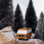 CandyLab Volkswagen T3 Campervan in brown - front view, on a rock in a snowy forest environment. 