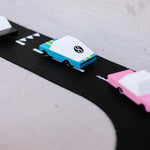 Close up of the candylab blue racing car model on a black toy road set