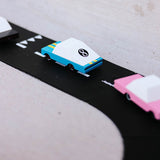 Close up of the candylab blue racing car model on a black toy road set