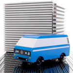 CandyLab blue VW T3 CandyVan with white stripe on the side - parked in front to a metal cube.