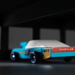 Close up of the back of the Candylab plastic-free racing car toy on a black and grey background