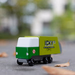 Close up of the Candylab toy garbage truck on the ground surrounded by fallen leaves