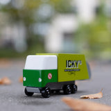 Close up of the Candylab toy garbage truck on the ground surrounded by fallen leaves