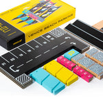 Pieces of the Candylab magnetic wooden parking garage toy set laid out next to the box on a white background