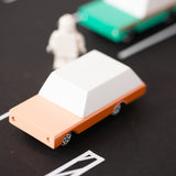 Close up of the candylab solid wooden brown car toy on a black rubber road
