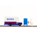 Candylab wooden diecast post van on a black rubber road next to a toy figure and mailbox toy