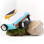 Candylab childrens collectable blue car toy on some grey rocks and small ball of moss
