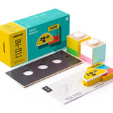 Pieces of the Candylab collectable taco shack model on a white background next to its cardboard box