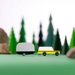 Candylab wooden airtsream and suv toy on a green background in front of some toy trees