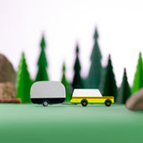 Candylab wooden airtsream and suv toy on a green background in front of some toy trees