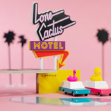 Candylab kids duckie wagon car toy on a white background in front of the Candylab wooden toy motel set