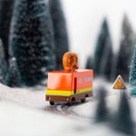 Close up of the Candylab collectable wooden pretzel van toy on a toy road surrounded by miniature trees and snow