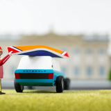 Close up of a toy figure putting the miniature wooden kayak on top of the Candylab blue suv toy