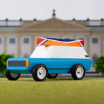Candylab solid wooden cotswold royale toy car on a green background in front of a model palace
