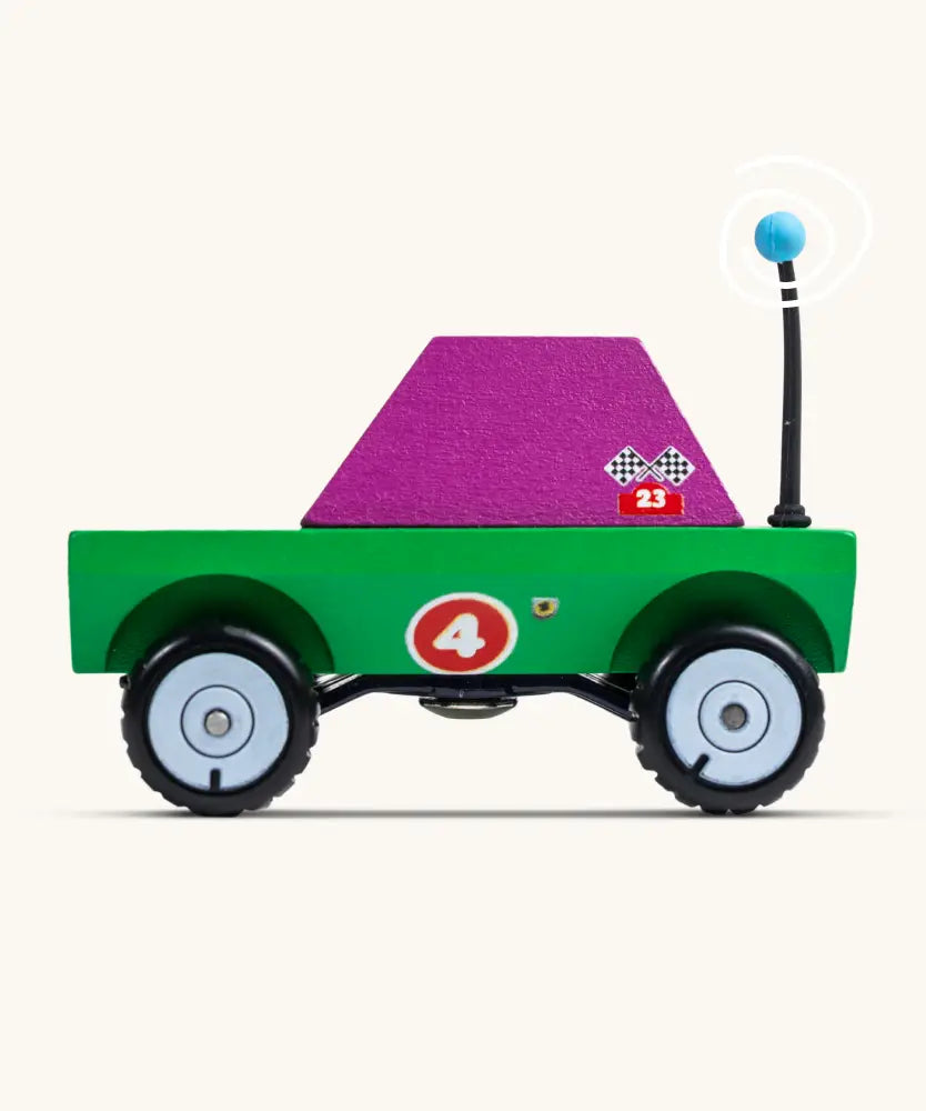 Side of Candylab Dundee wooden diecast adventurer truck with a green body and purple windows and decals