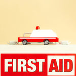 Candylab eco-friendly wooden ambulance car toy on top of a white first aid box