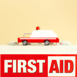 Candylab eco-friendly wooden ambulance car toy on top of a white first aid box