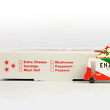 Close up of the Candylab kids toy pizza delivery truck on a red and black pizza box