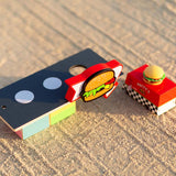 Candylab toy burger shack and burger van on a sandy background
