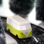 CandyLab green VW T1 Campervan - front  view, driving through a snowy forest.