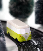 CandyLab green VW T1 Campervan - front  view, driving through a snowy forest.