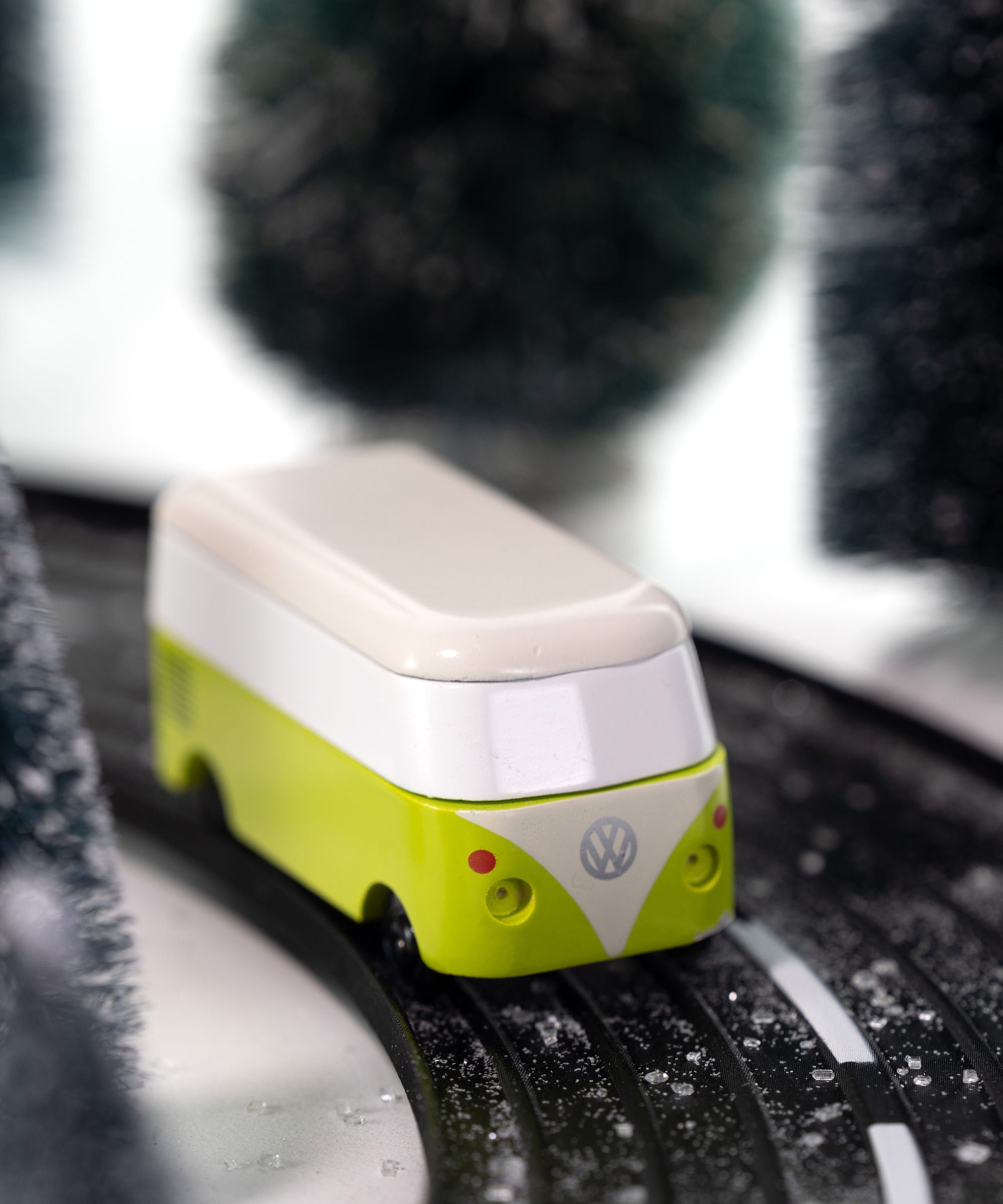 CandyLab green VW T1 Campervan - front  view, driving through a snowy forest.