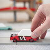 Adult hand pushing a Candylab hachigo red toy car on a playroad showing scale