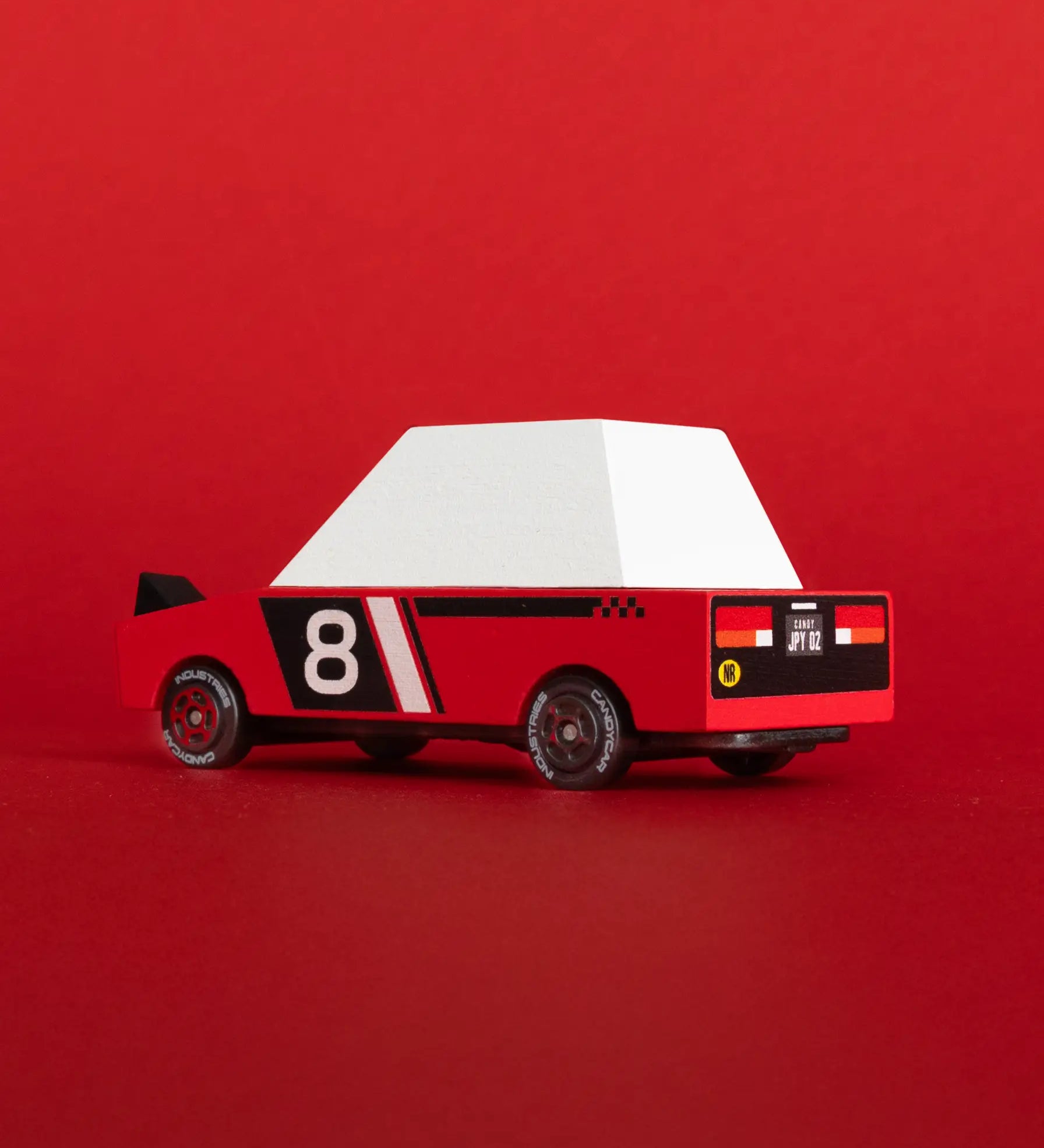 Candylab Hachigo red racer a red body, pop up headlights and retro no8 decals in front of a bright red car
