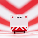 Close up of the back of the Candylab solid wooden ambulance van toy on a red and white striped background