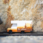 Side of the Candylab collectable campervan diecast toy in front of a large stone background