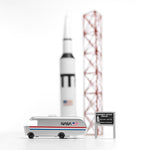 Candylab NASA astro van toy on a white background next to a miniature rocket ship