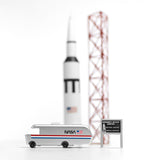 Candylab NASA astro van toy on a white background next to a miniature rocket ship